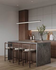 a kitchen with an island and stools in it