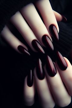 Dark red gothic nails are perfect for the October Halloween season. These nails are long and pointed, with a dark red polish over the black base is both mysterious and alluring. You can also add black lace, for a gothic aesthetic. #gothicnails #darkrednails #moodynails #fallnails #halloweennails Black And Dark Red Nails, Vampire Nails Aesthetic, Red Gothic Nails, Red Wedding Nails, Talon Nails, Vampire Oc, Vampire Nails, Red Gothic