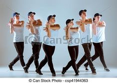 a group of young people in white shirts and black pants are dancing with their hands together