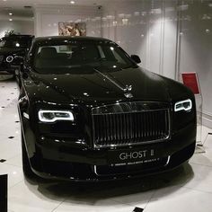 a black car is on display in a showroom