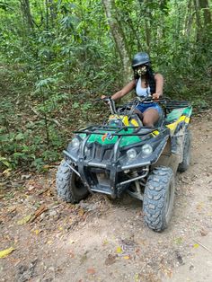 a woman riding on the back of an atv