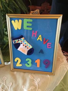 two framed pictures with the words we have a pair of socks on them, and one is