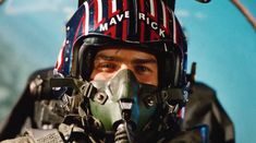 a man wearing a helmet and goggles in front of an american flag background with the words warrick written on it