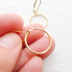 "A great basic for secure everyday wear, these super lightweight goldfilled earrings feature hammered hoops measuring just over half an inch. . { d e t a i l s } . Made to order. goldfilled . { m e a s u r e m e n t s } . ~ 1/2\" from the bottom of the earwires . { o p t i o n s} . View other delicate earring options: http://www.etsy.com/shop/CamileeDesigns?section_id=10244959 . { p a c k a g i n g } . Your jewelry will arrive in a sweet gift box . { s h i p p i n g } . Handmade in my studio and Everyday Hammered 14k Gold Filled Earrings, Simple Hammered Everyday Earrings, Simple Everyday Hammered Earrings, Gift 14k Gold Filled Hammered Hoop Earrings, Dainty Hammered Hoop Earrings, Everyday Small Hoop Hammered Earrings, Hammered Open Circle Earrings For Everyday, Delicate Earring, Best Friends Sister