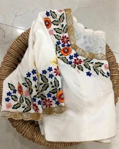 Blouses with colorful floral motifs are exceptionally popular nowadays. Resham work come in different colors suit an individuals style sense, this can help you to make a style statement of your own. Note: The chart mentions Body Measurements and not the garment dimensions. Fabric: Pure silk Neck: U neck at front and back Princess cut front. Bust pad: With or without cup insert. Half sleeve Front hook closure Cotton lining Color- Custom Colors possible. Size: All sizes possible This is made to or White Blouse Designs, Resham Work, Latest Model Blouse Designs, Cutwork Blouse Designs, Blouse Design Images, New Blouse Designs, Princess Jewelry, Ladies Blouse Designs, Maggam Work Blouse Designs