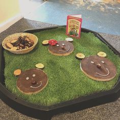 a table that has some food in it on top of green grass with little faces drawn on them