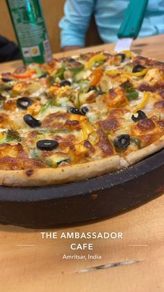 a pizza sitting on top of a wooden table