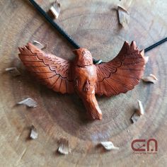 a wooden bird on a leather cord necklace