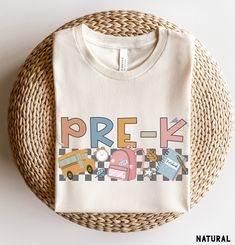 Pre-K Shirt, Pre K Teacher Shirts, Pre-K Crew Shirts, Back to School Shirts, Retro Pre-K Tee, PreK Squad,  Kids Pre K Shirt More Grades and Styles Here: https://www.etsy.com/shop/TheGraphicPeach?ref=seller-platform-mcnav§ion_id=34195008 For environmental and human friendly reason, this product is only made when you order. Turnaround time is usually 1-5 business days before shipping, but can increase during holiday periods. Our professional printers always strive to ship as quickly as possible, but faster times are not guaranteed. Our printer uses direct-to-garment printing to make our products. The design ink is sprayed on, then allowed to soak into the fibers of the garment. This process yields fine quality prints and a smooth finish on the garment. BELLA + CANVAS UNISEX T SHIRT The Bella Cute School Shirt With Crew Neck, White Cotton Tops For Back To School, Cute White Tops For Back To School, Cute Crew Neck Shirt For End Of School Year, Cute Graphic Print Shirt For Back To School, Playful Cotton Shirt For End Of School Year, Cute Multicolor School Shirt, Playful Cotton Tops For Back To School, Casual Long Sleeve Tops For Back To School