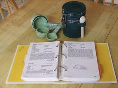 an open recipe book sitting on top of a wooden table