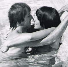 a man and woman in the water holding each other