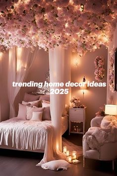 a bedroom decorated in white with pink flowers on the ceiling and lights hanging from the ceiling