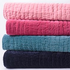 four blankets stacked on top of each other