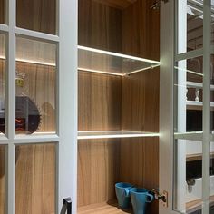 the shelves in the room are made of wood and have glass inserts on them