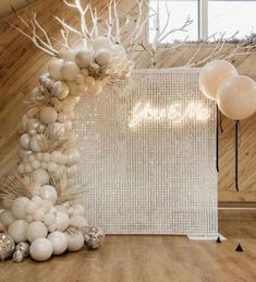 balloons are arranged on the floor in front of a white wall and wooden paneled walls