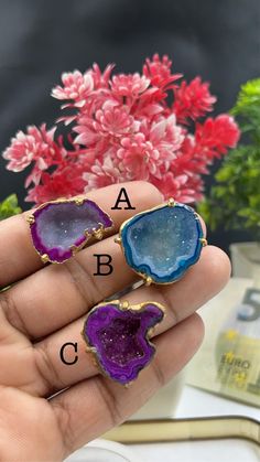 Introducing our stunning Geode Rings - nature's hidden treasures transformed into exquisite jewelry! Each Geode Ring showcases the unique beauty of geodes, with their captivating crystals and vibrant colors. Elevate your style and connect with the Earth's natural wonders. Discover the magic of geodes with our Geode Rings today! 🔸Adjustable band ring 🔸30mm stone size 🔸Color may vary according to lighting 🔸Gold filled Rock Ring, Large Geode, Rough Stone Ring, Geode Ring, Rock Rings, Raw Crystal Ring, Raw Gemstone Ring, Unique Beauty, Crystal Ring