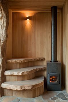 a wood burning stove sitting in the corner of a room next to some stone steps