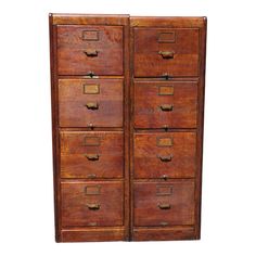 an old wooden filing cabinet with many drawers on the top and bottom, against a white background