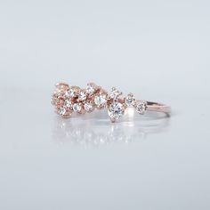 This graceful and delicate ring features a cluster of 18 tiny white diamonds ranging from 2.5mm~1.4mm. Like two beautiful swans intertwined together sparkly under the sunlight. Made in 14k Yellow gold, rose gold and white gold. Simple and classic for everyday wear or as a ceremonial piece, and can be pair with your solitaire. This ring is designed and made in New York City.Materials:- 14K solid gold- Cz or natural white diamonds - Natural diamonds option is approx. 0.4ct total carat weight. SI2 Rose Gold Cluster Ring With Brilliant Cut, Rose Gold Cluster Promise Ring, Fine Jewelry Rose Gold Rings With Sparkling Stones, Rose Gold Cluster Ring With Rose Cut Diamonds, Sparkling Rose Gold Fine Jewelry Rings, Rose Gold Cluster Ring For Anniversary, Cluster Rose Gold Cubic Zirconia Ring, Rose Gold Cluster Diamond Ring With Rose Cut Diamonds, Anniversary Rose Gold Cluster Ring