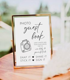 a photo guest book sitting on top of a wooden table