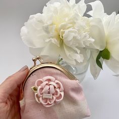 "Rose Gold Kisslock Coin Purse, also known as \"Gamaguchi\" in Japan.  Made with Pink/White \"Muddy Works\" pink light weight cotton canvas fabric and adorned with a Kanzashi peony flower, this compact purse is a stylish accessory. Its metal clasp closure provides easy access, while the beige/pink floral cotton lining adds a touch of elegance. Our Rose Gold Kisslock Coin Purse is a testament to impeccable craftsmanship and attention to detail. Its elegant design, combined with the traditional elements of Kanzashi, creates a unique and eye-catching piece.  It's perfect for your essentials. Elevate your style with this beautifully crafted coin purse. Finish size (approximate) 10cm (L) x 11cm (H) x 2cm (W)" Vintage Pink Coin Purse As Gift, Pink Vintage Style Coin Purse Gift, Handmade Pink Pouch Coin Purse, Handmade Pink Coin Purse, Pink Pouch Coin Purse Gift, Pink Pouch Coin Purse As Gift, Vintage Pink Wallets For Gifts, Pink Vintage Wallets For Gifts, Beautiful Hair Accessories