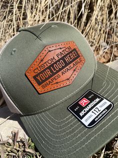 These leather patch Richardson 112FP hats are a great way to flaunt your style and look sleek at the same time. Patches made from 100% leather and engraved with a crisp design and hand stitched on our most popular style of hat. Your friends are going to be jealous! To submit custom logo- Please email brent@lumberjackdesignco.com with the Vector logo, it will be labeled .eps, .ai, .pdf (Please do not submit a jpg in this format as this will need redrawn and art charges will apply for hourly rates!) Multiple hat colors available, Bulk pricing available (see below) custom shape patches available upon request. SIZE OF PATCH HEIGHT WILL VARY DEPENDING ON CUSTOMER LOGO If a hat color is not listed please message us and we can order in a custom color if needed. Casual Leather Trucker Hat With Leather Patch, Brown Snapback Hat With Custom Logo For Outdoor, Casual Leather Trucker Hat With Patch, Trucker Style Leather Snapback Hat With Leather Patch, Leather Hats For Outdoor Activities With Flat Bill, Leather Snapback Trucker Hat For Outdoor Activities, Leather Flat Bill Hat For Outdoor Activities, Leather Snapback Hat With Flat Bill And Leather Patch, Casual Leather Trucker Hat With Logo Patch