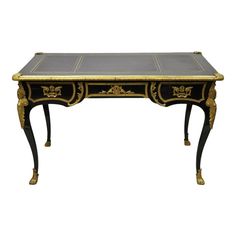 an antique black and gold desk with two drawers on one side, the top is turned down