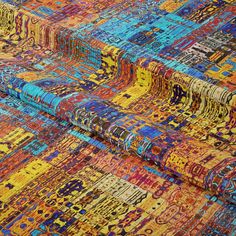 multicolored area rug with various patterns and colors on the ground, closeup