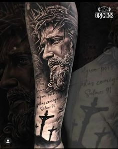 a man with a cross and jesus tattoo on his arm