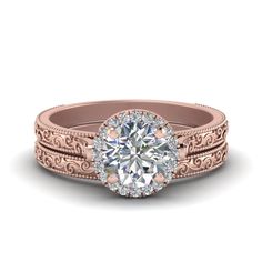 a rose gold engagement ring set with an oval center stone and filigrees