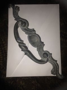 an old fashioned metal handle on a piece of paper