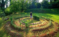 a person standing in the middle of a garden