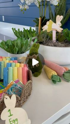 a table topped with lots of toys and plants