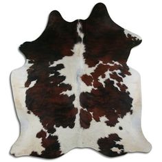 a brown and white cowhide rug on a white background