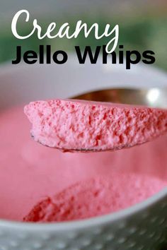 a spoon full of pink jello with the words, creamy jello whips