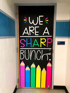 a classroom door decorated with chalk and crayons that says we are a sharp bunch