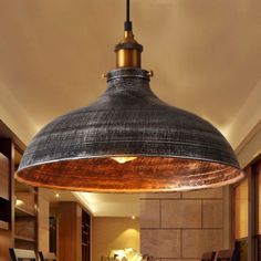 an industrial style pendant light hanging over a kitchen island