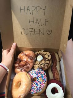 an open box filled with lots of doughnuts