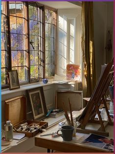 an artist's studio with easels and paintings