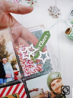 someone holding up some christmas cards with pictures on them