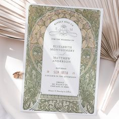 an ornate wedding card on top of a table