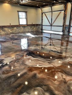 a large room with shiny floors and stone walls