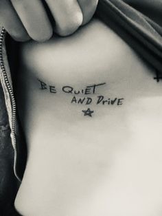 a person with a tattoo that says be quiet and drive on their side ribcage