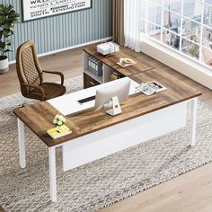 an office desk with a chair and computer on it in front of a large window