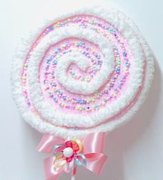 a candy lollipop with pink, white and blue sprinkles