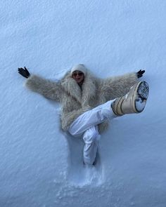 a person laying in the snow with their legs spread out