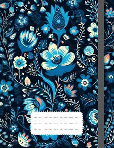 a blue notebook with flowers and leaves on the cover, in front of a black background