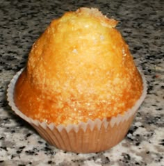 a muffin sitting on top of a granite counter