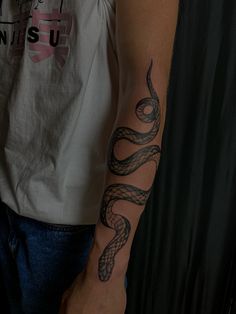 a man with a snake tattoo on his arm