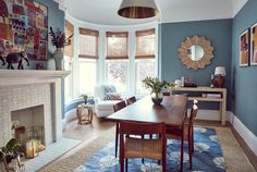 a dining room with blue walls and furniture